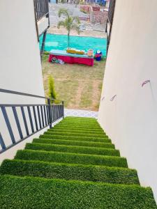 a stairway with a view of a pool at Qcent Bairagarh Resort Rishikesh in Mohan Chatti
