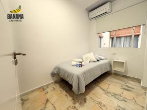 a bedroom with a bed with towels on it at Banana Gay House - Only Men in Seville