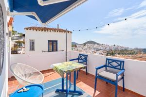 un balcone con tavolo e sedie e vista di La Casa Bonita a Frigiliana