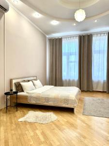 a bedroom with a bed and a large window at Apartments with a coffee machine in the city center, near the theater and Zlata Plaza in Rivne