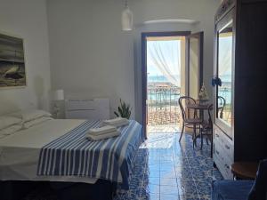 a bedroom with a bed and a view of the ocean at Camera con Vista in Termoli
