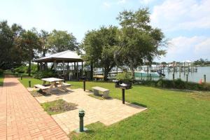a park with a picnic table and a pavilion next to the water at Shipwatch B101 in Perdido Key