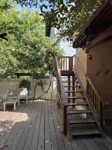 a wooden staircase leading up to a house at Lovely Guest House- אירוח בכפר סבא in Kefar Sava