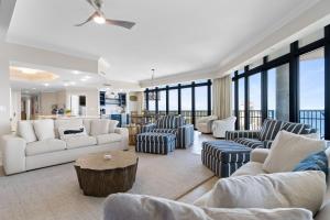 a living room with couches and chairs and windows at The Oasis at Orange Beach 2411 (Phoenix West II) in Orange Beach