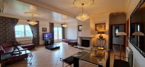 a living room with a table and a fireplace at Villas de Nazare in Maceira