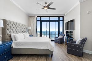 a bedroom with a large bed with a large window at The Oasis at Orange Beach 2411 (Phoenix West II) in Orange Beach +114 photos