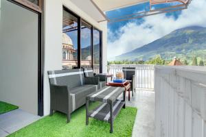 a balcony with a view of a mountain at Hotel O Guesthouse Sabar Makmur Kledung Syariah in Temanggung