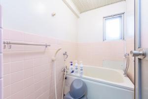 a bathroom with a bath tub and a toilet at Nagoya 12min Legoland 25min 3BR 4Beds Sofa 9ppl in Nagoya +48 photos