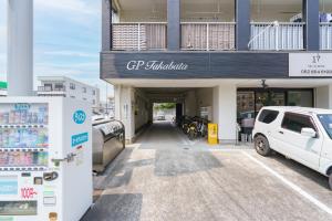 a car parked in a parking lot in front of a building at Nagoya 12min Legoland 25min 3BR 4Beds Sofa 9ppl in Nagoya
