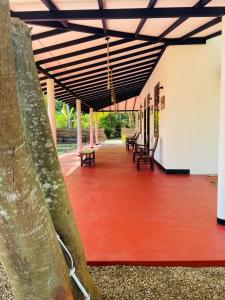 a group of benches sitting in a building at Dedunu Resort & Yala Safari in Tissamaharama