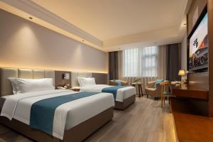 Katil atau katil-katil dalam bilik di Tongren Golden Beach Hotel