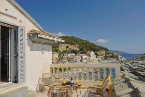 a patio with chairs and a table on a balcony at Casa Di U Mare in San-Martino-di-Lota +21 photos