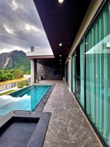 a swimming pool in the middle of a building at Song View Pool Villa in Vang Vieng
