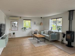 a living room with a couch and a table at Beautiful cottage with ocean view in Esbjerg