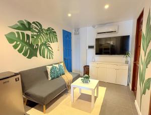 a living room with a couch and a table at The Blue Doors- Siargao in General Luna