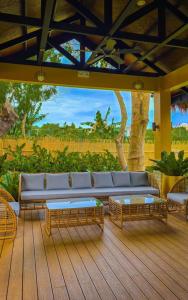 a living room with a couch and tables on a deck at Heart of Mactan Newtown big space with free wifi and pool access in Punta Engaño