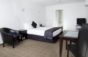 Ένα ή περισσότερα κρεβάτια σε δωμάτιο στο Hygate Motor Lodge