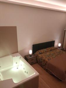 a bathroom with a bath tub and a bed at Igg VATICAN HOLIDAY in Rome