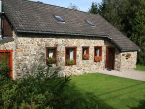 a stone house with flowers in the windows at Elegant Bevercé Escape in Malmedy +32 photos