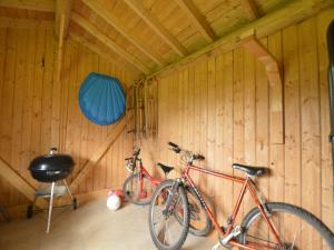 two bikes parked in a room with wooden walls at Elegant Bevercé Escape in Malmedy
