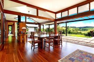 an open dining room with a table and chairs at Bodhi Nature in Coorabell Creek