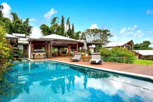 a swimming pool in front of a house at Bodhi Nature in Coorabell Creek