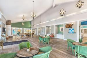 a lobby with green chairs and tables and tablespaces at Hilton Vacation Club Beachwoods Kitty Hawk in Kitty Hawk
