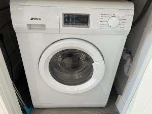 a white washing machine sitting in a room at 5 Aviv Place in Addlestone
