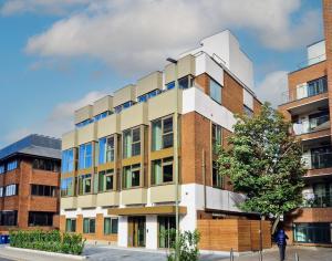 a building with a tree in front of it at 300m to Totteridge and Whetstone Tube Station Modern Living new Flat in Whetstone