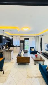 a living room with a couch and a table at Ikamba Homes-Munyonyo in Kampala