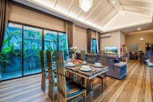a living room with a table and a couch at Sky Blue Pool Villa at Hua Hin 3Bedrooms and 4 Bathrooms near Cha-Am beach in Nikhom Sang Ton Eng Khuan Phet