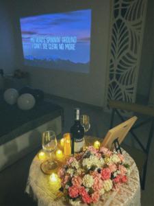 a table with candles and flowers and wine glasses on it at Thẩn Thơ Homestay in Hue