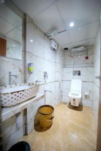 un baño con inodoro y lavabo en N M Hotel Nr kokilaben Hospital, en Bombay