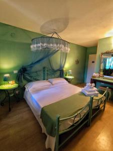 a bedroom with a large bed with a canopy at B&B Terramare in Montiano +100 photos
