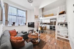 a living room with a couch and a table at London Lets Stay Here with parking in Ilford