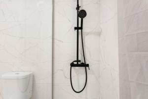 a shower with a glass door in a bathroom with a toilet at Moradia Centro Da Cidade Funchal in Santa Luzia +14 photos