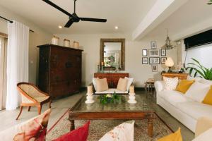a living room with a couch and a table at Arahtis Lake Villa in Hikkaduwa