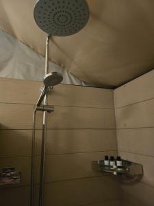 a shower with a shower head in a bathroom at Windy Hills Bungalow in Belihul Oya