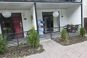 a porch of a house with plants in front of it at TESTkg in Cholpon-Ata