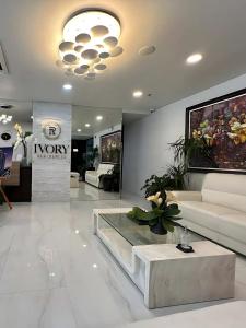 a living room with a couch and a table at Davao Condo Bed Space - Safe, Affordable & Comfy in Davao City +25 photos