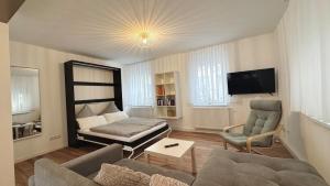 a living room with a couch and a bed at 2-Zimmer-Wohnung-Küche-Bad-Terrasse, Bahnhofsnähe in Mühlacker