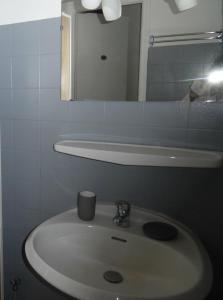 a bathroom with a white sink and a mirror at Les Morèses in Amélie-les-Bains-Palalda