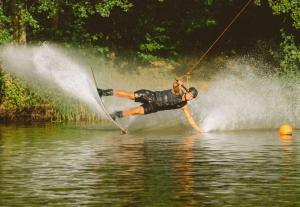 a man is water skiing on a lake at 1 bedroom with private bathroom & Kitchenette in Oberthulba