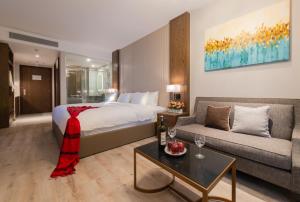 a hotel room with a bed and a couch at HD Panorma Nha Trang Free Pool & Gym Condotel in Nha Trang +25 photos