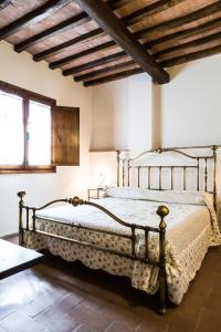 a bedroom with a metal bed in a room at Agriturismo Casa VolaterrA in Volterra