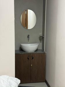 a bathroom with a sink and a mirror at Krushnkunj Executive in Kolhapur +28 photos