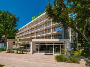 an office building with a sign on top of it at ibis Styles Golden Sands Roomer Hotel in Golden Sands