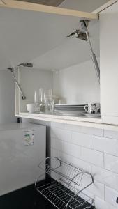 a kitchen with a dish rack on the counter at Studio espaço Bom Retiro in Sao Paulo