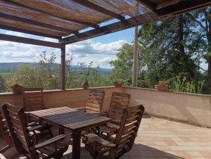 a wooden table and chairs on a patio at BB La Terrazza in Trevi