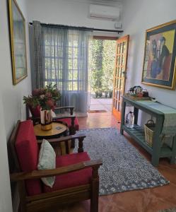 a living room with a chair and a table at Ilnika Farm Stay in Naboomspruit